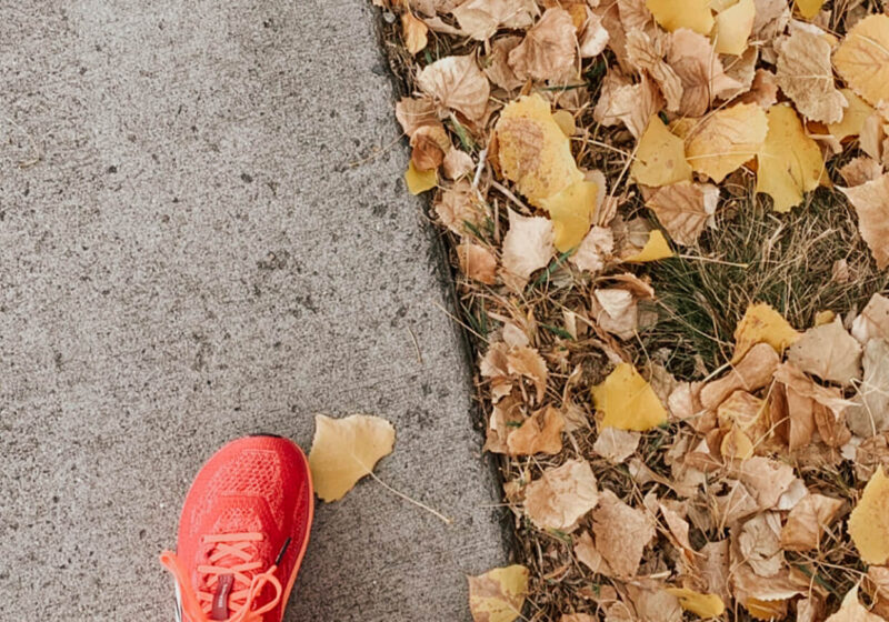 benefits to walking daily. Walking on pavement next to fall leaves